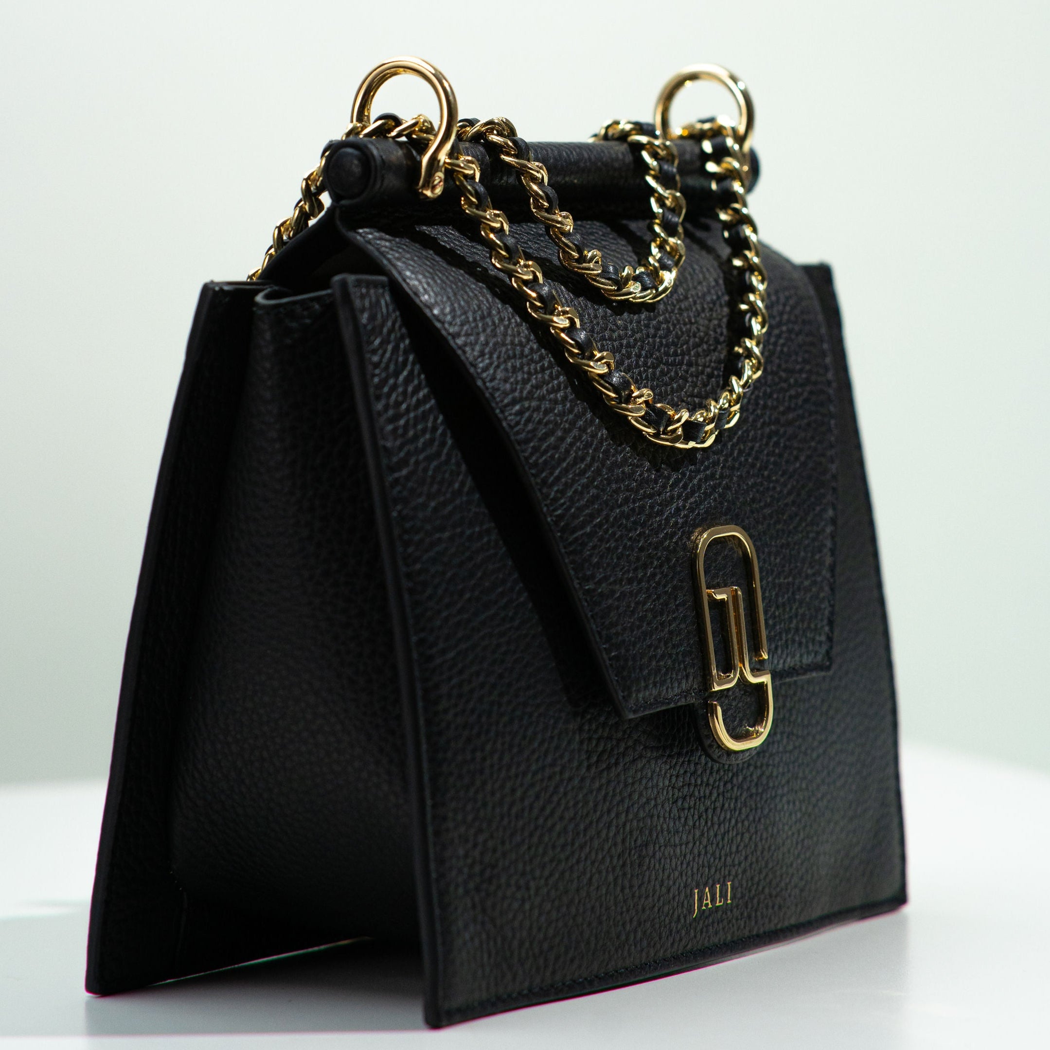 Side view of Cleopatra Bag in Black by Jali, showcasing full-grain leather, gold-plated hardware, and modern architectural design – Australian luxury handbag